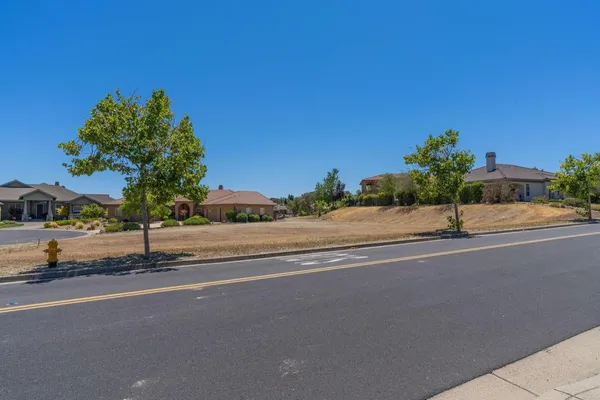 a view of a parking space and a yard