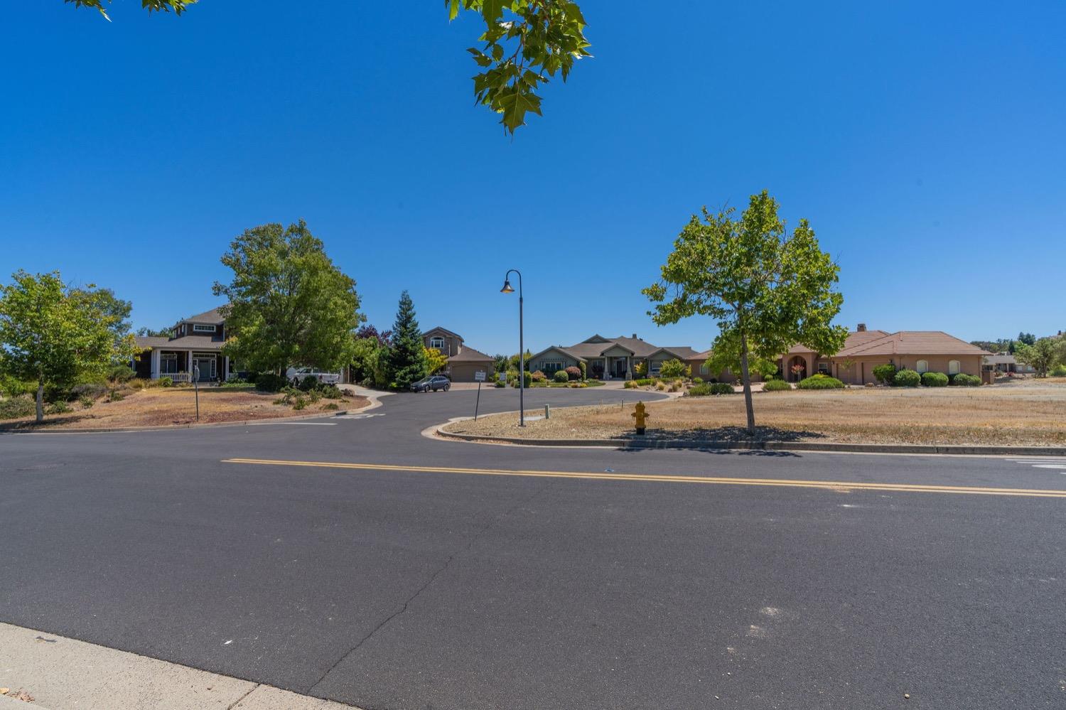 10 Flagstone Court, Unit 1 COPPER RIDGE 32 Copperopolis, CA 95228 - Photo 10 of 31 a view of a road with a building in the background