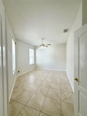 a view of an empty room and a window