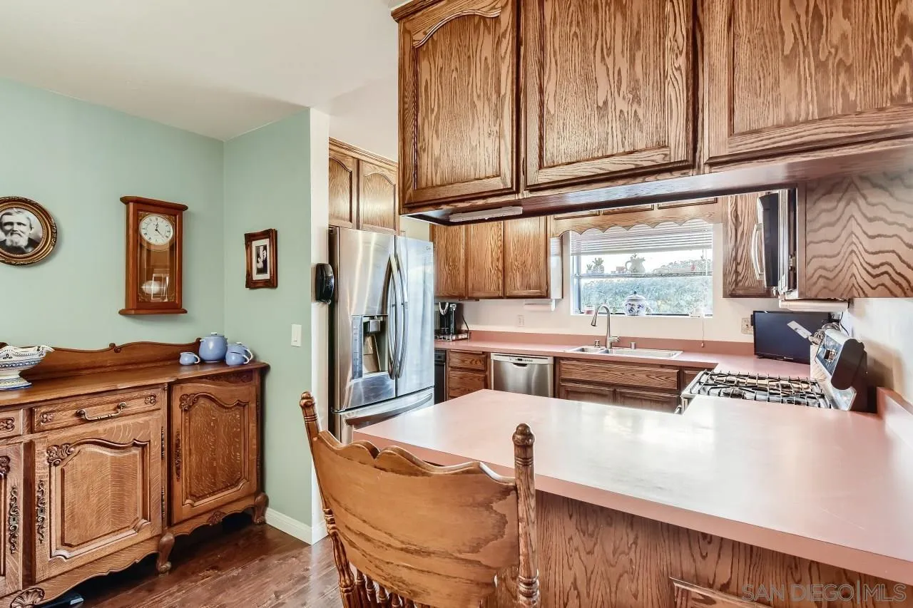 10027 Pebble Beach Drive Santee, CA 92071 - Photo 11 of 25 a kitchen with stainless steel appliances granite countertop a stove a sink and a cabinets
