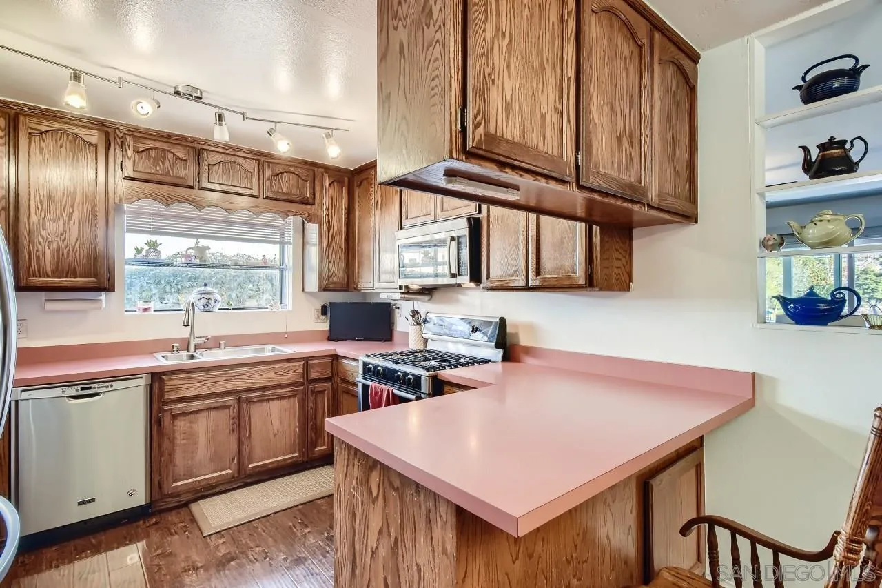 10027 Pebble Beach Drive Santee, CA 92071 - Photo 12 of 25 a kitchen that has a sink and a stove in it