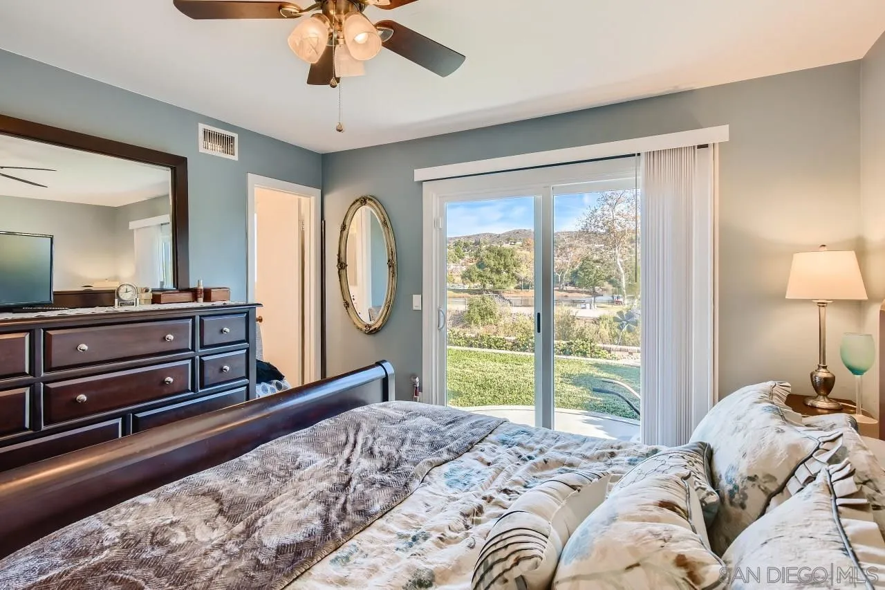 10027 Pebble Beach Drive Santee, CA 92071 - Photo 16 of 25 a bed room with a bed and a chandelier