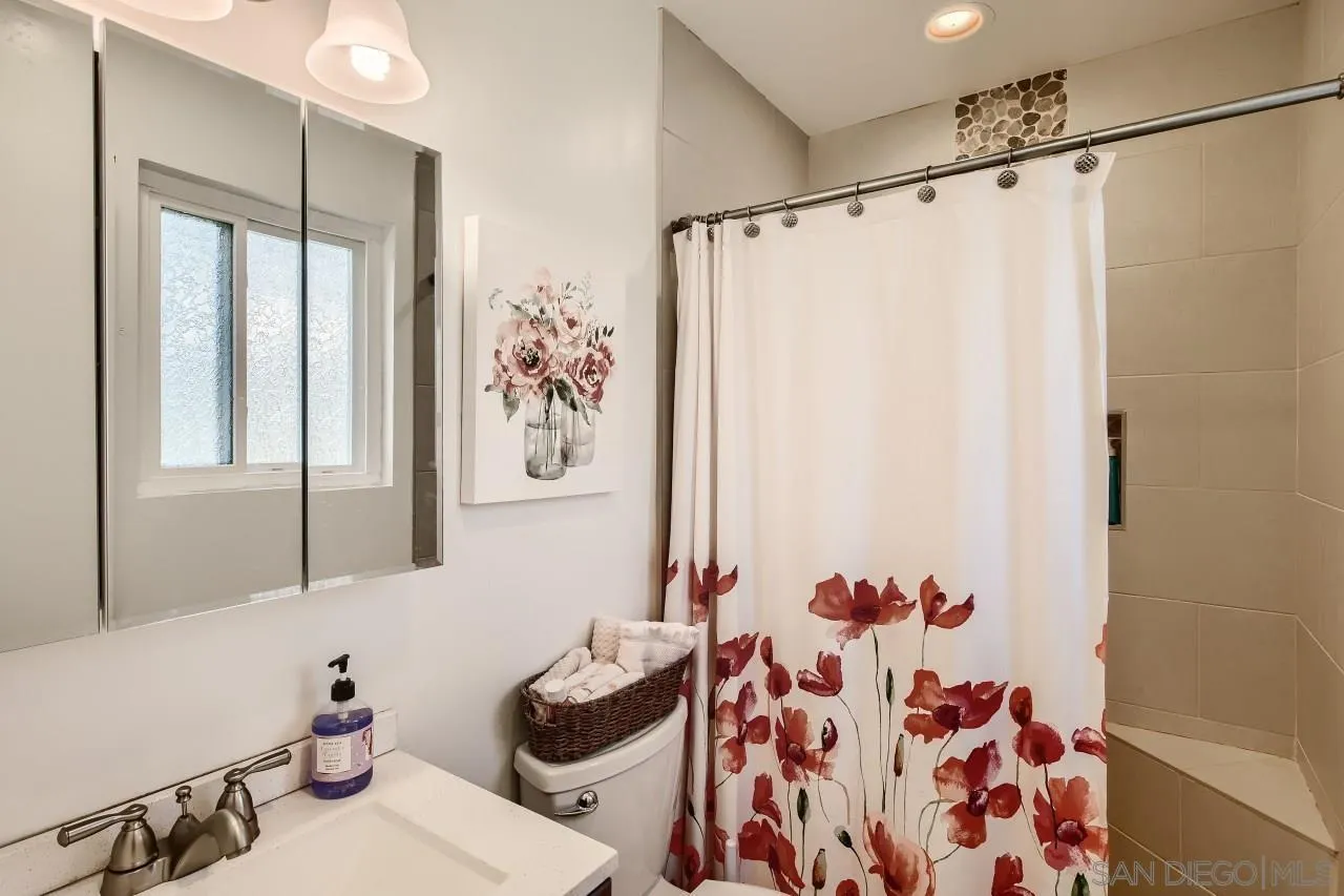 10027 Pebble Beach Drive Santee, CA 92071 - Photo 17 of 25 a bathroom with a sink and a mirror