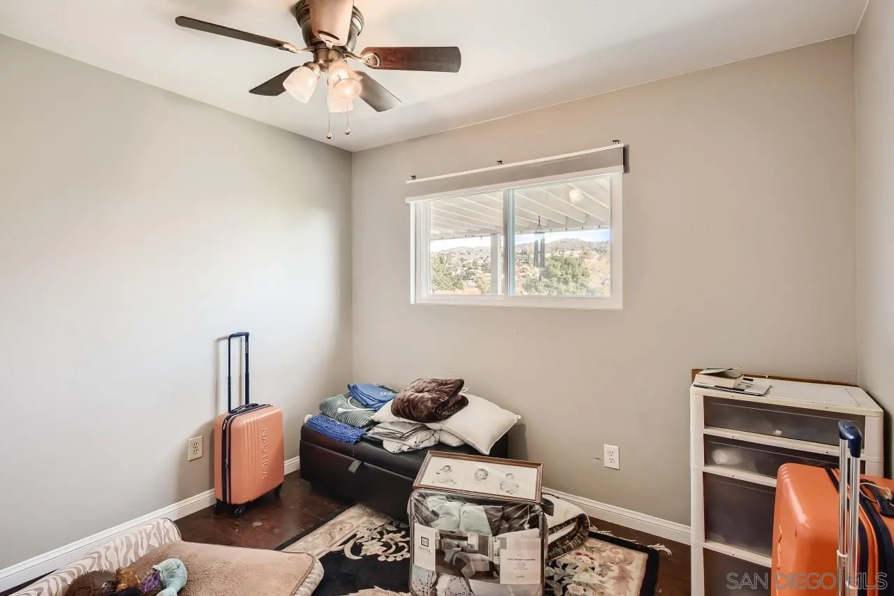 10027 Pebble Beach Drive Santee, CA 92071 - Photo 22 of 25 a living room with furniture a air conditioner and a window