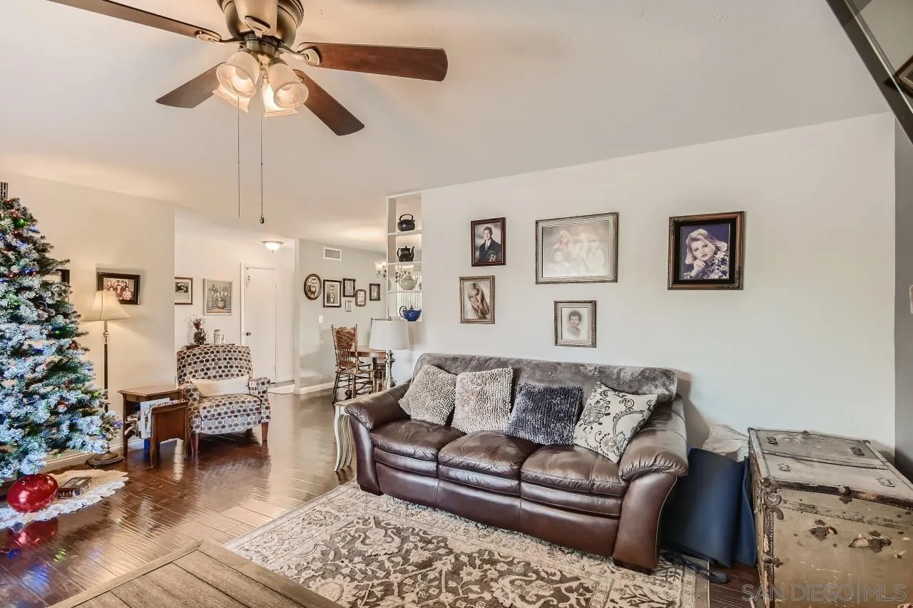 10027 Pebble Beach Drive Santee, CA 92071 - Photo 8 of 25 a living room with furniture and a chandelier