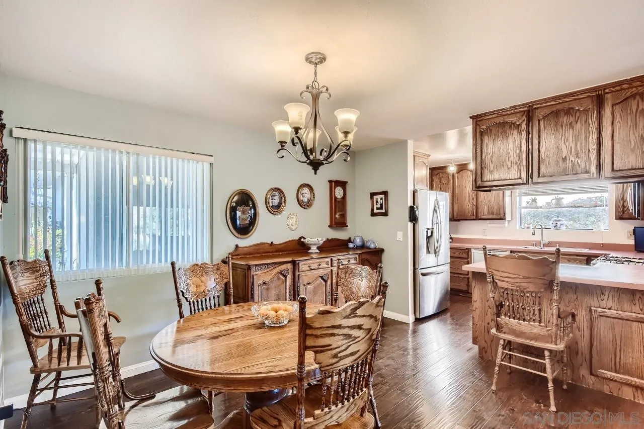 10027 Pebble Beach Drive Santee, CA 92071 - Photo 9 of 25 a view of a dining room with furniture a chandelier and wooden floor