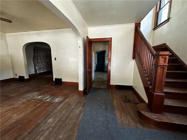 a view of entryway and hall with wooden floor
