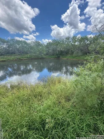 a view of a lake in between the two of trees