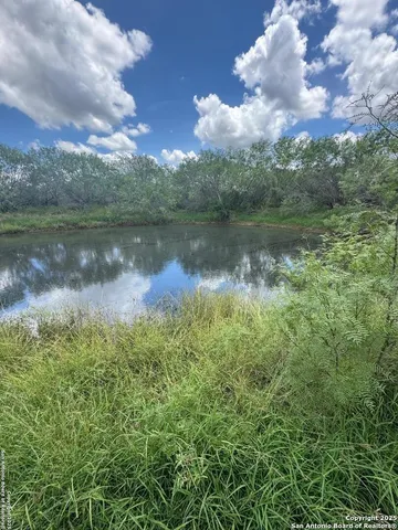 a view of a lake in between the two of trees