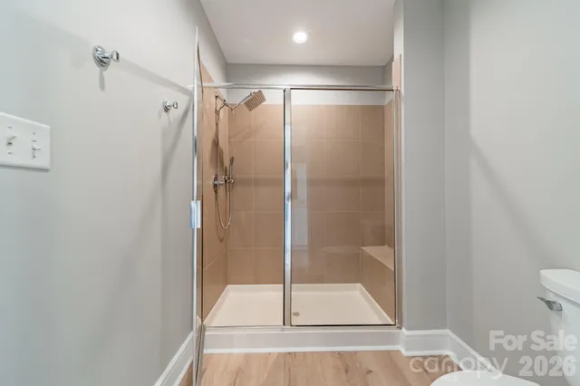 a bathroom with a glass shower door