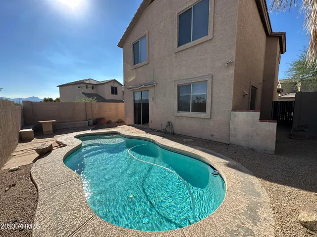 a swimming pool with outdoor seating