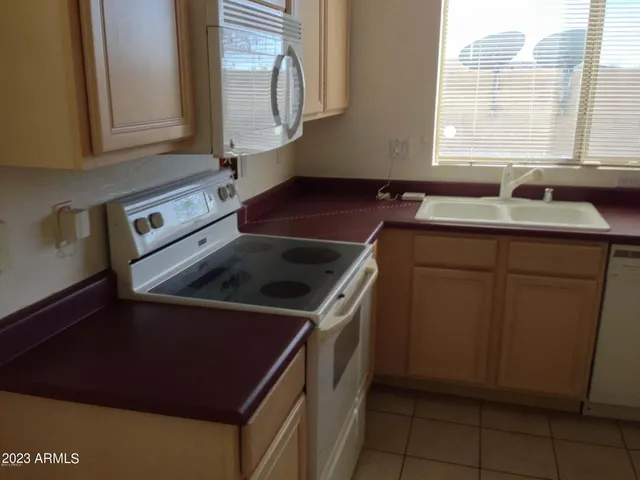 a kitchen that has a sink and a stove