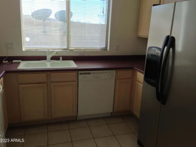 a kitchen with a sink and a refrigerator