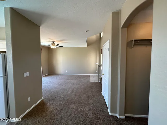 an empty room with windows and entrance