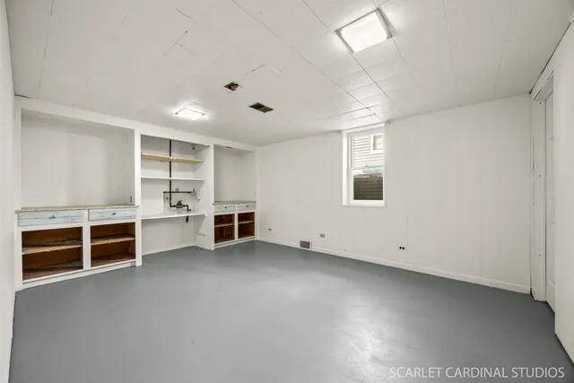 an empty room with furniture and window