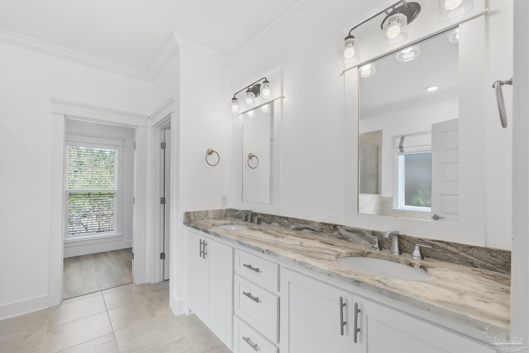 6264 Howie Way Pace, FL 32571 - Photo 16 of 42 a bathroom with a granite countertop sink and a mirror