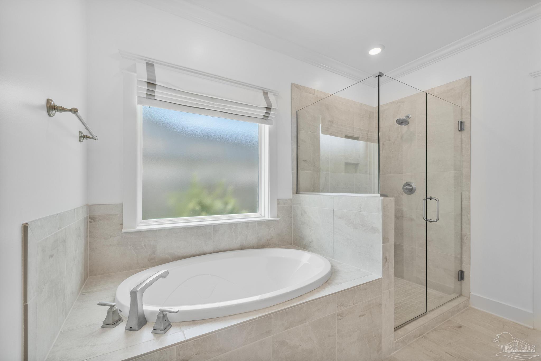 6264 Howie Way Pace, FL 32571 - Photo 17 of 42 a white bath tub sitting next to a shower