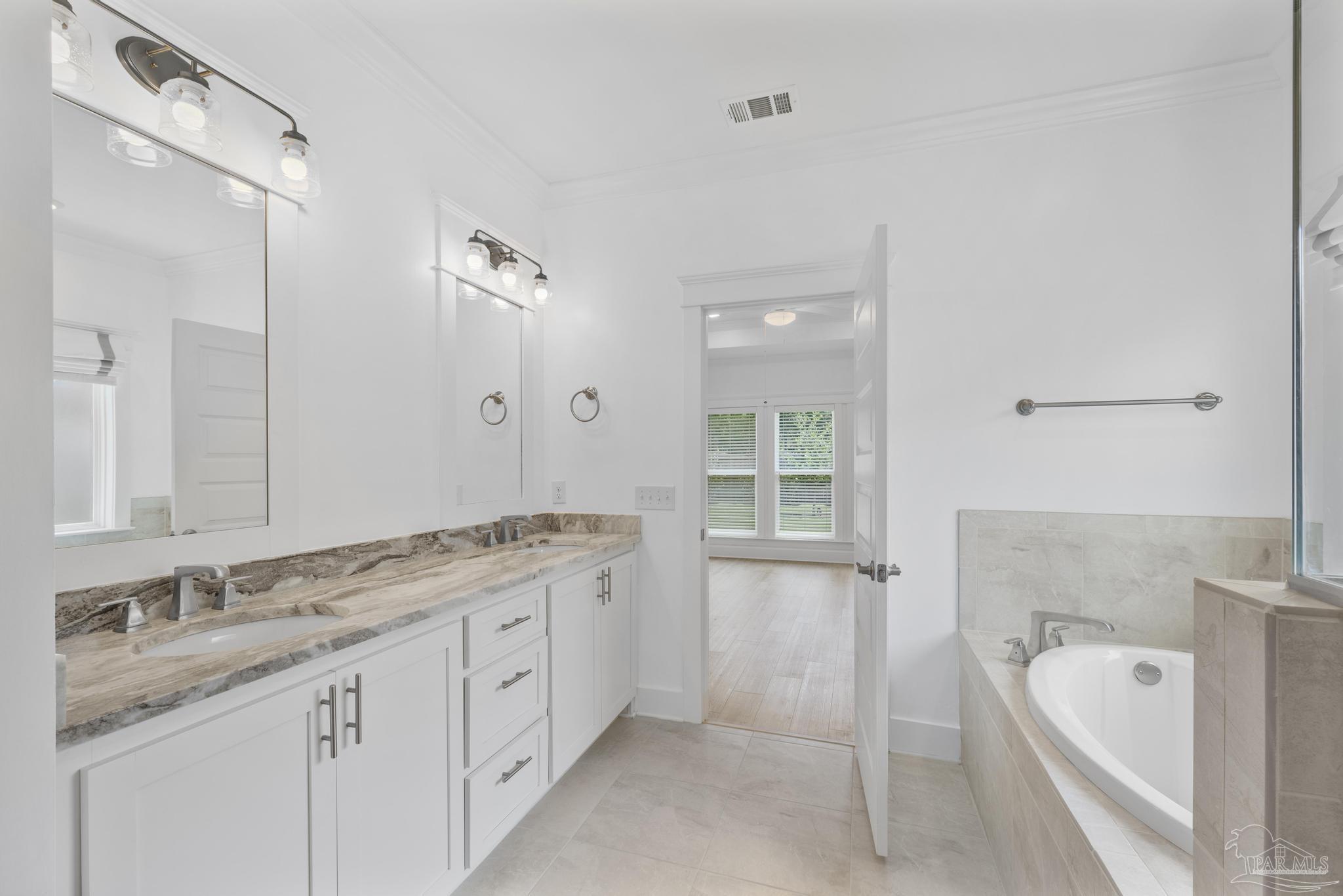 6264 Howie Way Pace, FL 32571 - Photo 18 of 42 a spacious bathroom with a granite countertop double vanity sink mirror and bathtub