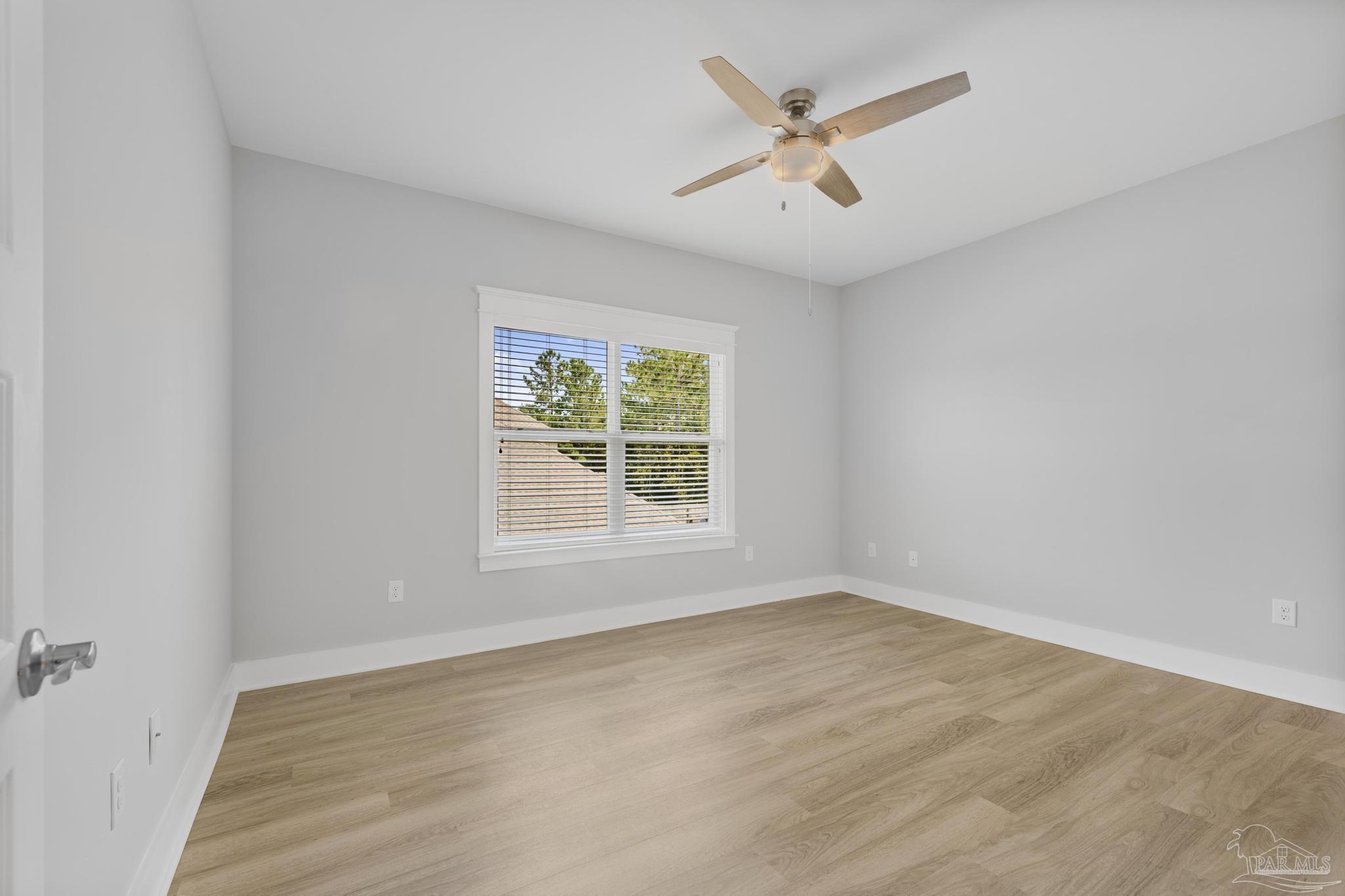 6264 Howie Way Pace, FL 32571 - Photo 24 of 42 wooden floor in an empty room with a window