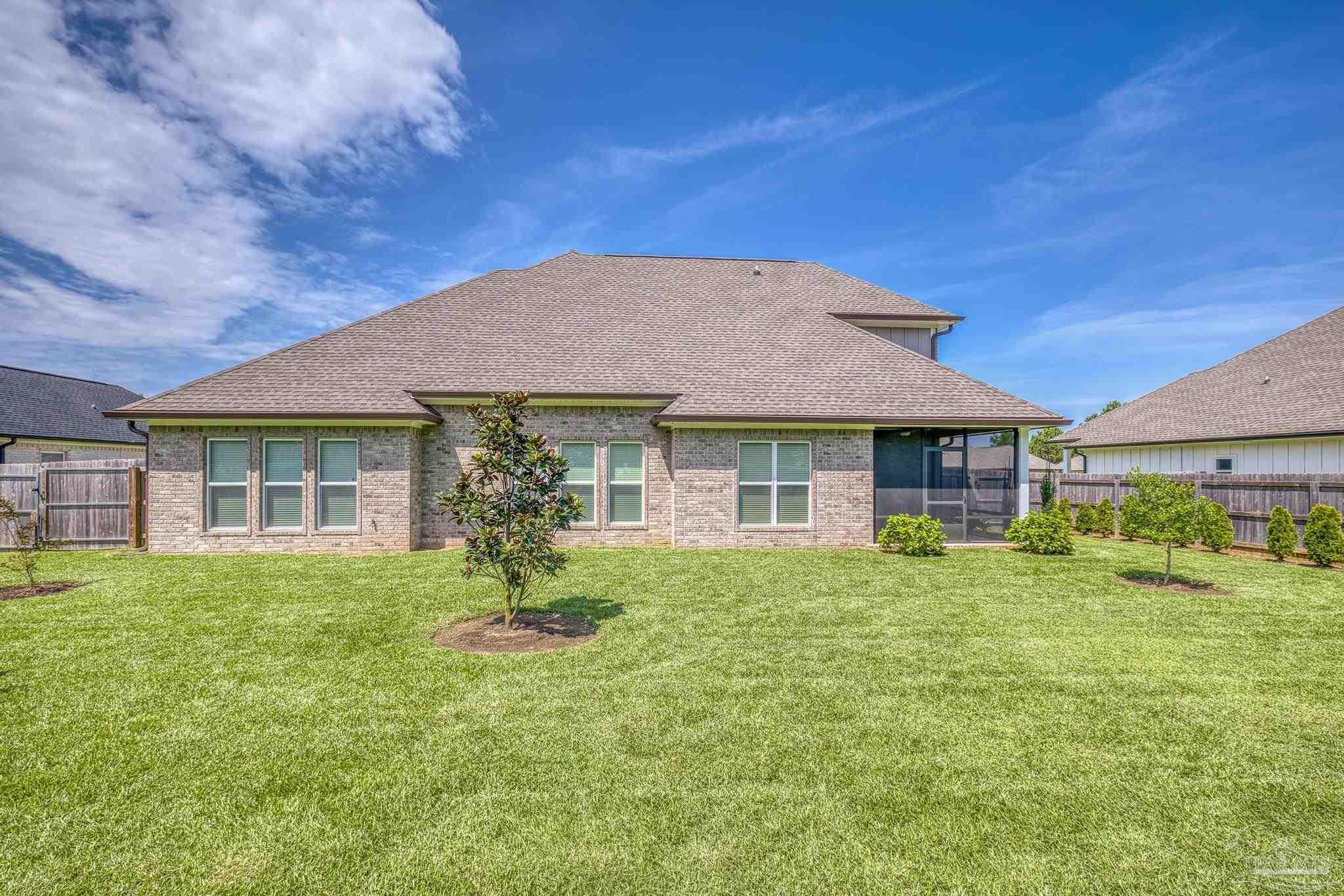 6264 Howie Way Pace, FL 32571 - Photo 32 of 42 a front view of a house with a garden