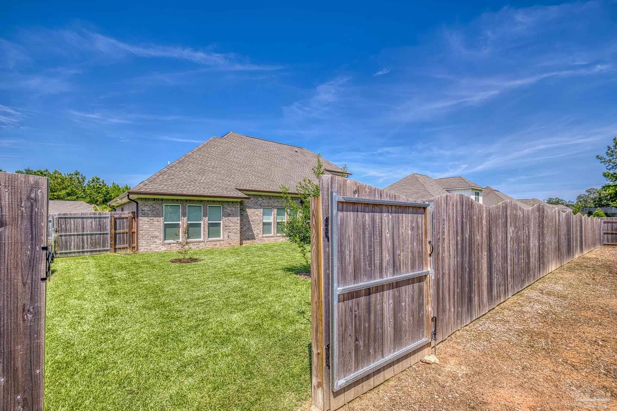 6264 Howie Way Pace, FL 32571 - Photo 33 of 42 a view of a house with wooden fence