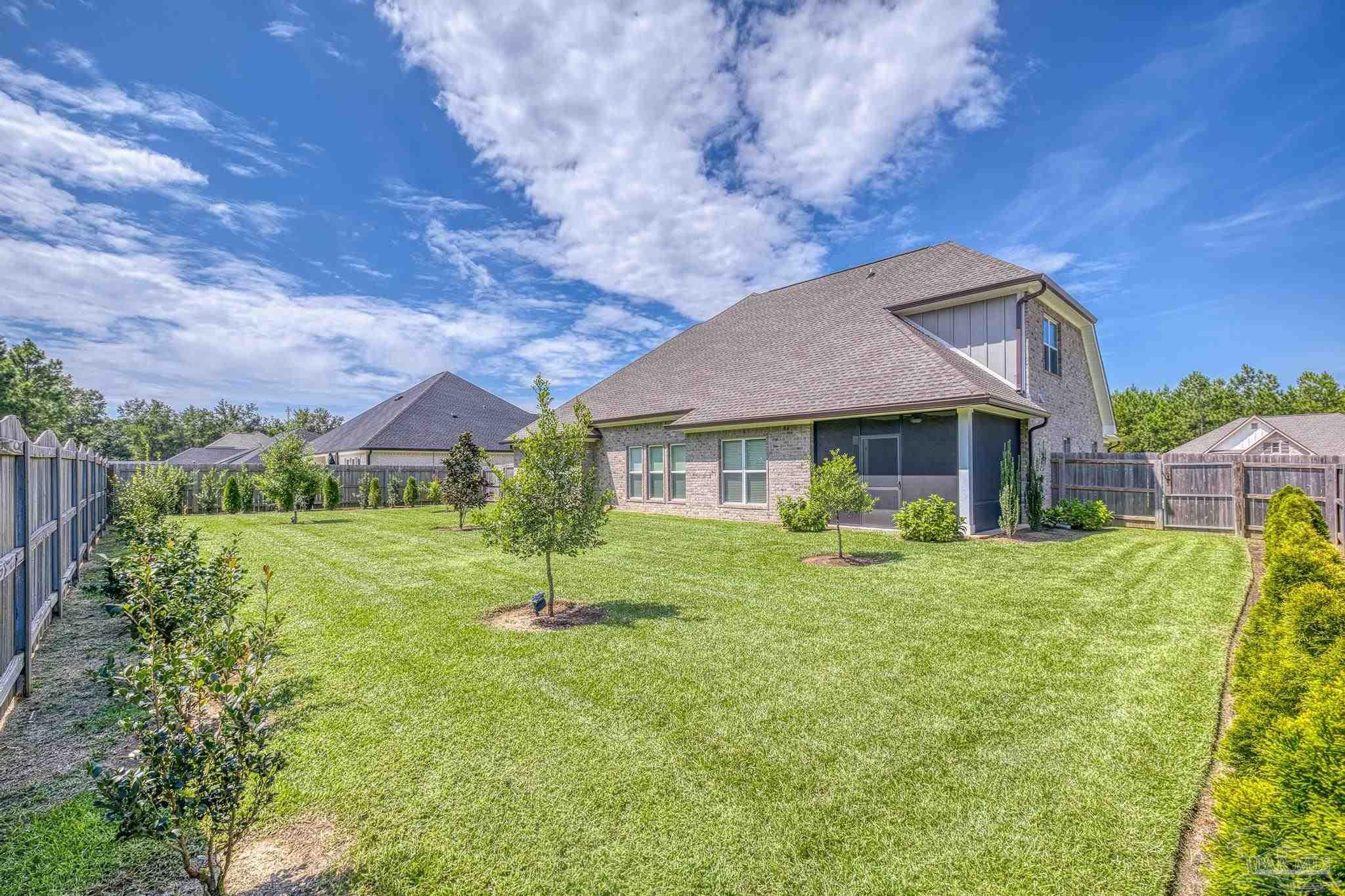 6264 Howie Way Pace, FL 32571 - Photo 6 of 42 a front view of house with a garden and porch
