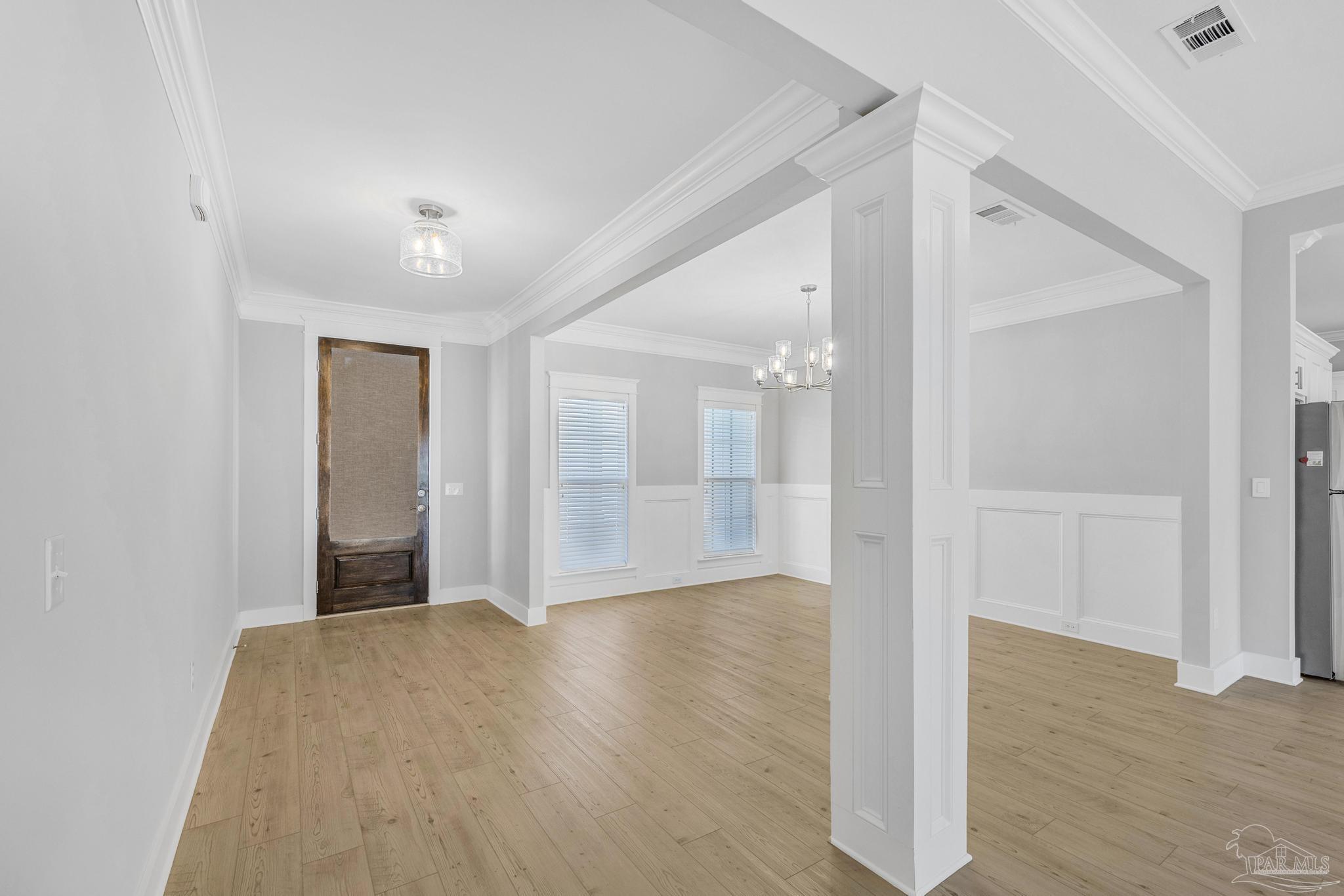 6264 Howie Way Pace, FL 32571 - Photo 9 of 42 a view of a big room with wooden floor and windows