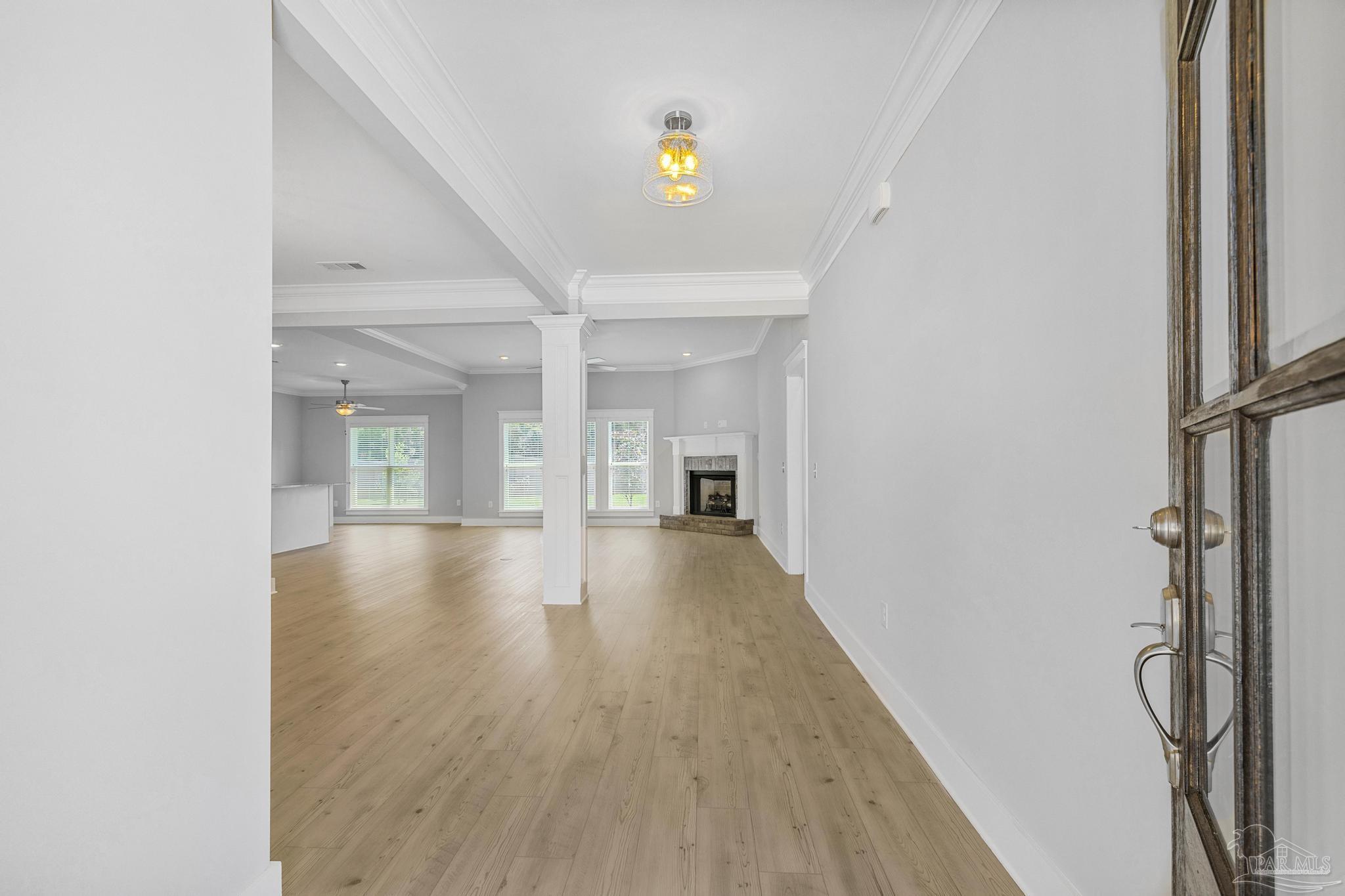 6264 Howie Way Pace, FL 32571 - Photo 10 of 42 a view of an empty room with wooden floor and a window