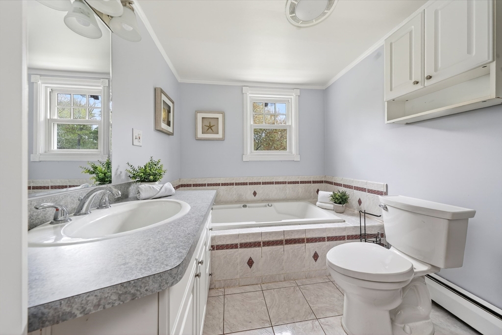 59 First Parish Road Norwell, MA 02061 - Photo 24 of 37 a bathroom with a sink a toilet and mirror