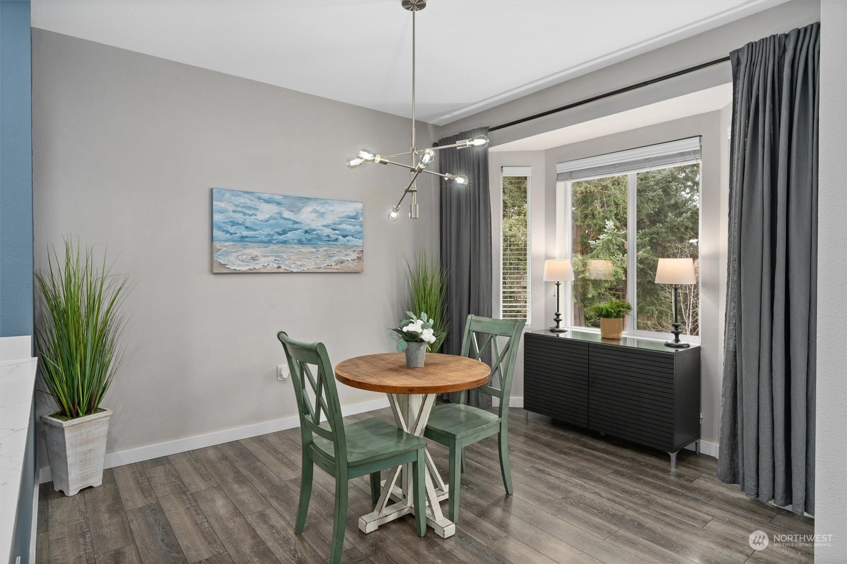 2810 Southeast 8th Street, Unit 2131 Renton, WA 98058 - Photo 11 of 35 a dining room with furniture potted plants and wooden floor