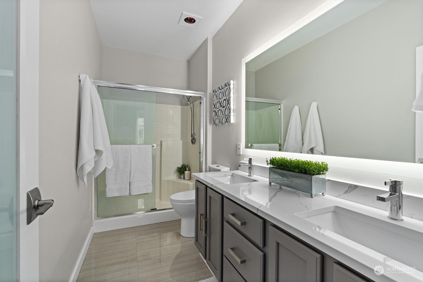 2810 Southeast 8th Street, Unit 2131 Renton, WA 98058 - Photo 19 of 35 a bathroom with a double vanity sink toilet and shower