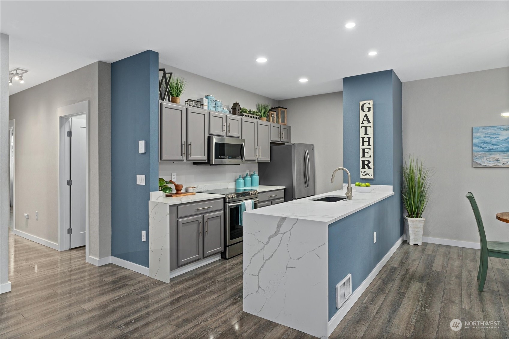 2810 Southeast 8th Street, Unit 2131 Renton, WA 98058 - Photo 2 of 35 a kitchen with kitchen island a sink stove and refrigerator
