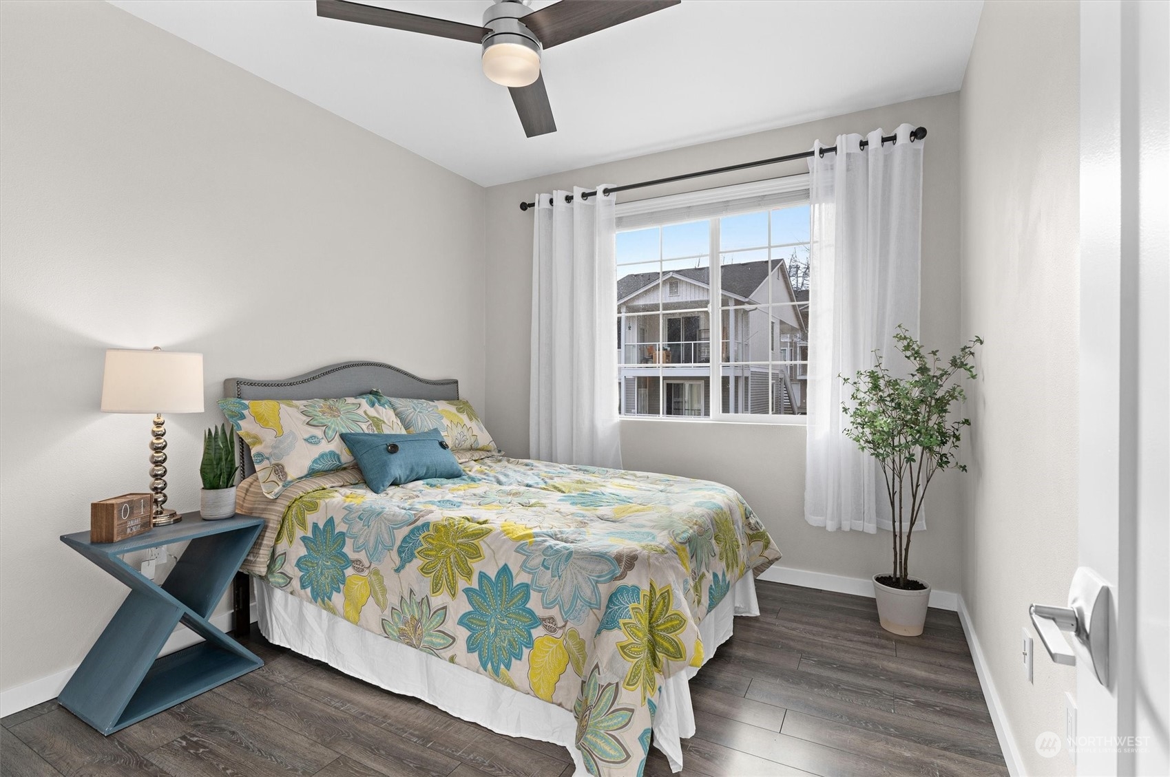 2810 Southeast 8th Street, Unit 2131 Renton, WA 98058 - Photo 21 of 35 a bedroom with a bed and wooden floor