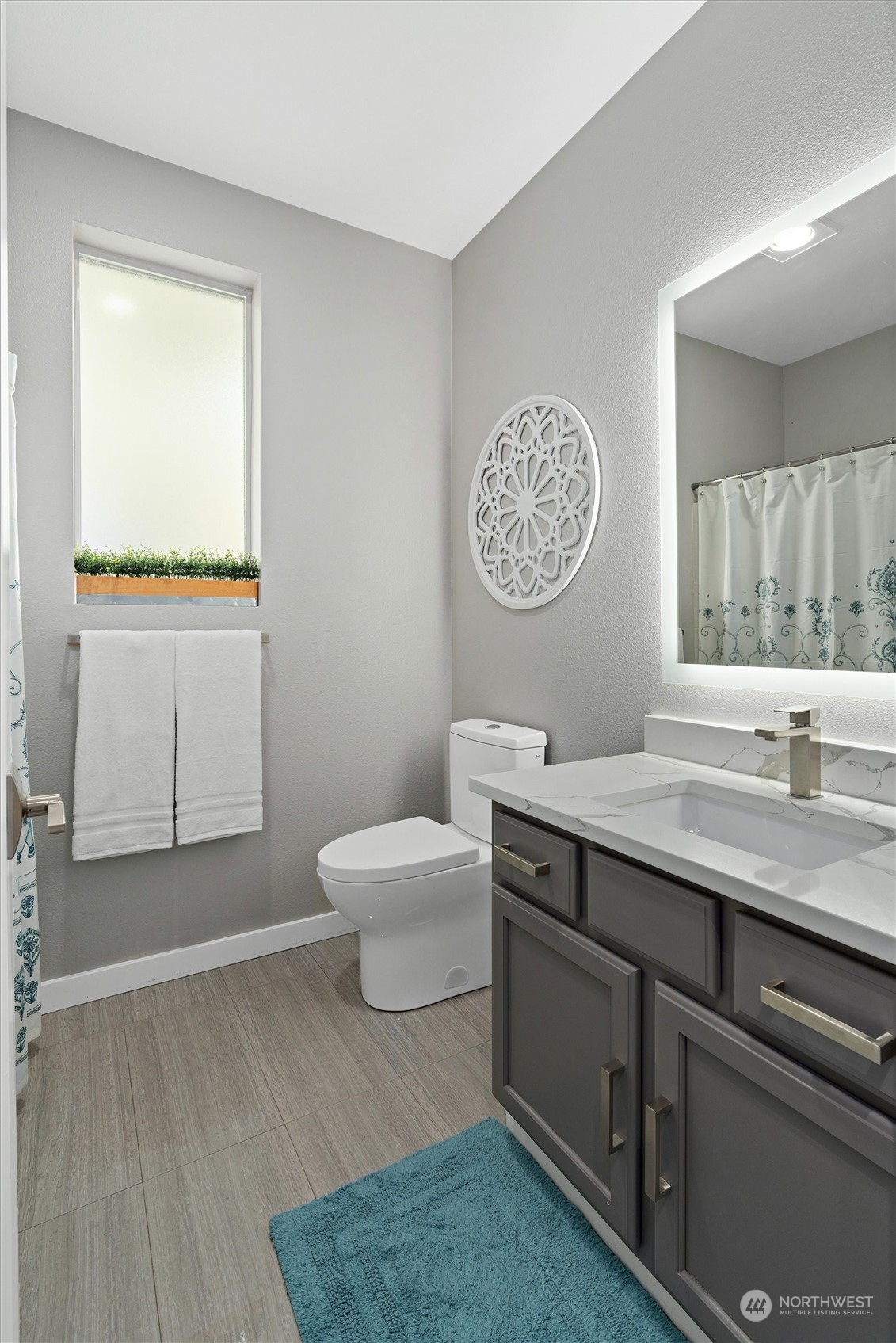 2810 Southeast 8th Street, Unit 2131 Renton, WA 98058 - Photo 23 of 35 a bathroom with a sink a mirror and a toilet