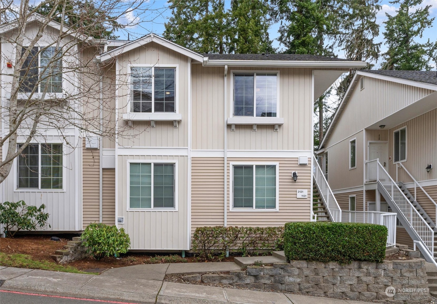 2810 Southeast 8th Street, Unit 2131 Renton, WA 98058 - Photo 27 of 35 a front view of a house with a yard and garage