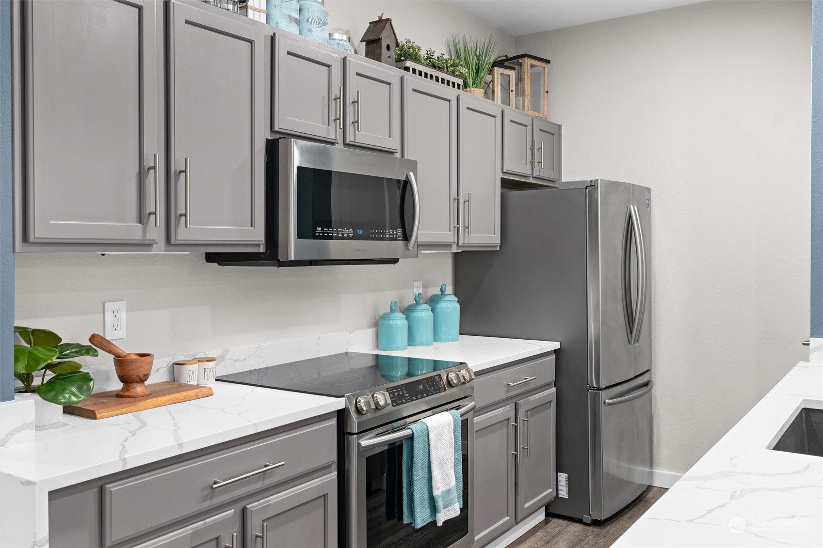 2810 Southeast 8th Street, Unit 2131 Renton, WA 98058 - Photo 3 of 35 a kitchen with stainless steel appliances a stove microwave and refrigerator