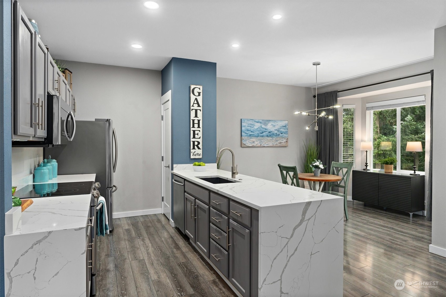 2810 Southeast 8th Street, Unit 2131 Renton, WA 98058 - Photo 4 of 35 a kitchen that has a lot of cabinets a sink and wooden floor