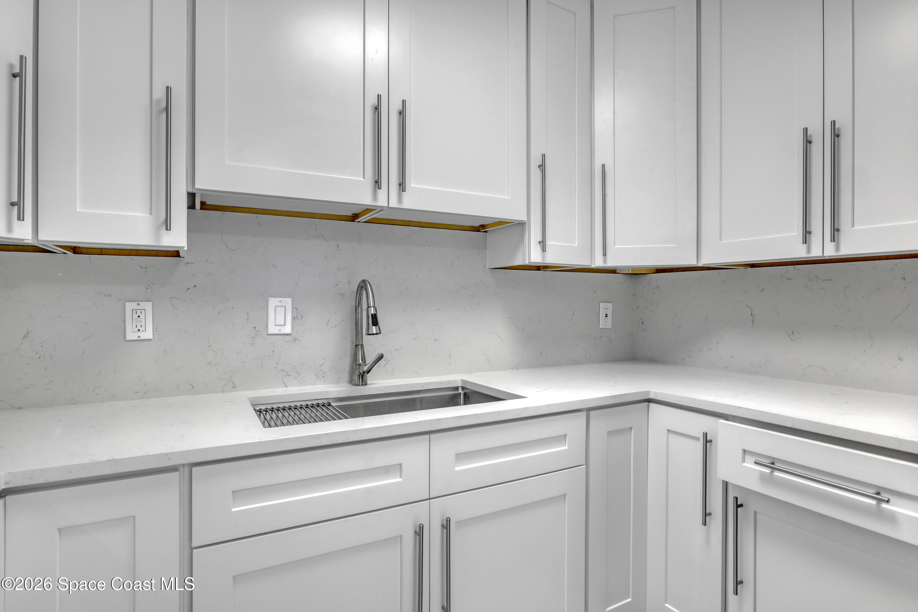 1051 Grove Avenue Cocoa, FL 32922 - Photo 11 of 38 a kitchen with white cabinets and a sink