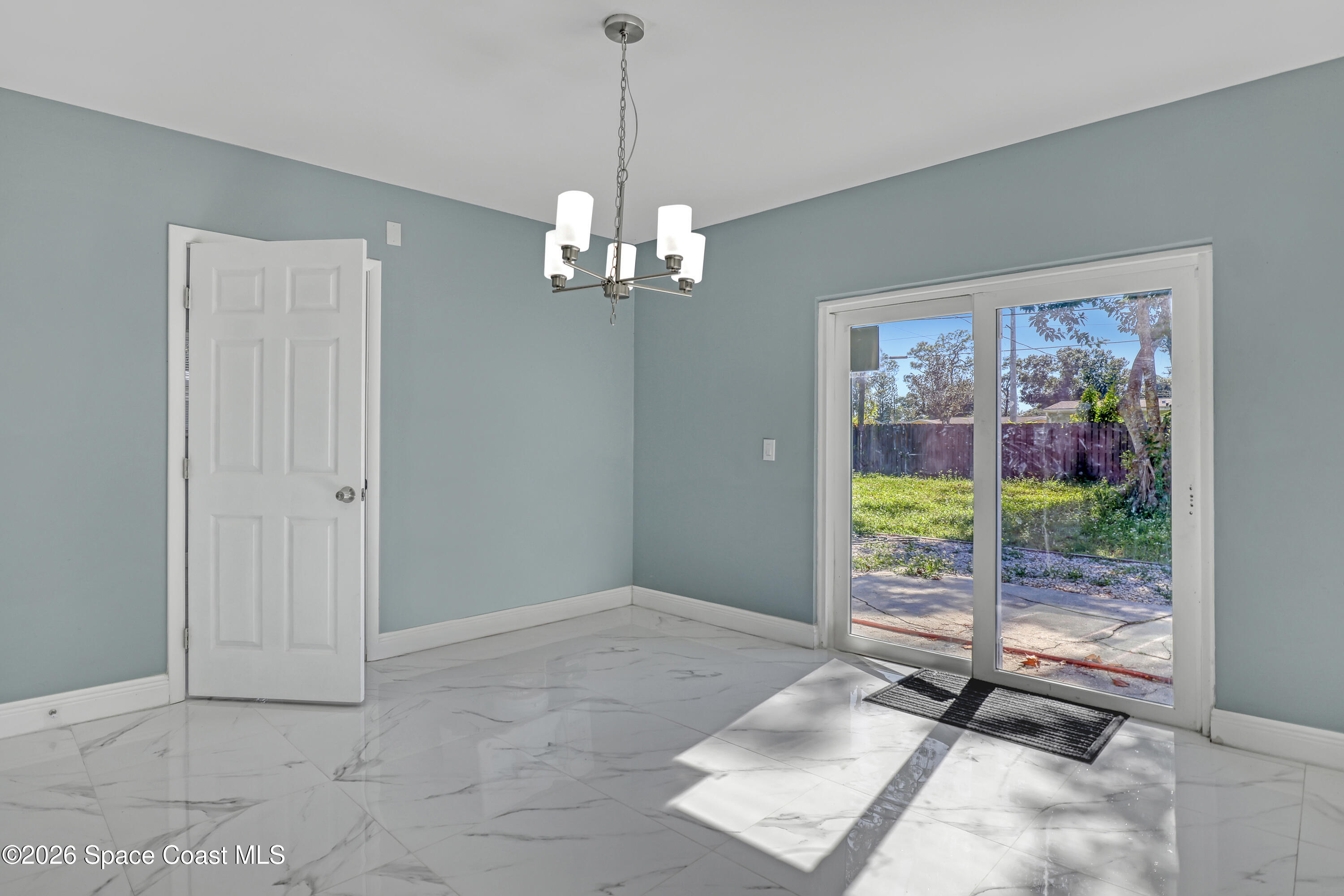1051 Grove Avenue Cocoa, FL 32922 - Photo 13 of 38 a view of a room with a chandelier and windows