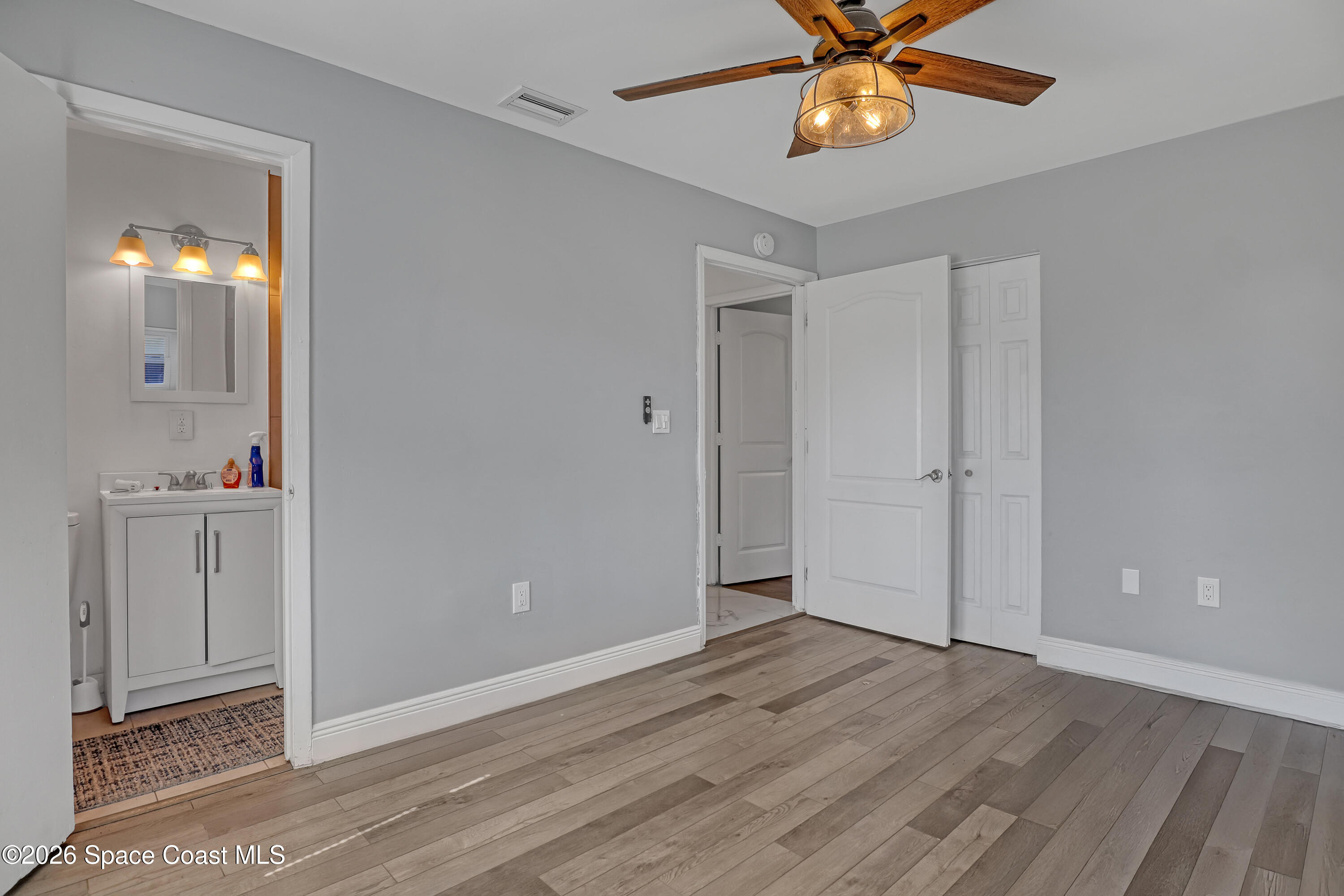 1051 Grove Avenue Cocoa, FL 32922 - Photo 18 of 38 wooden floor in an empty room with a window