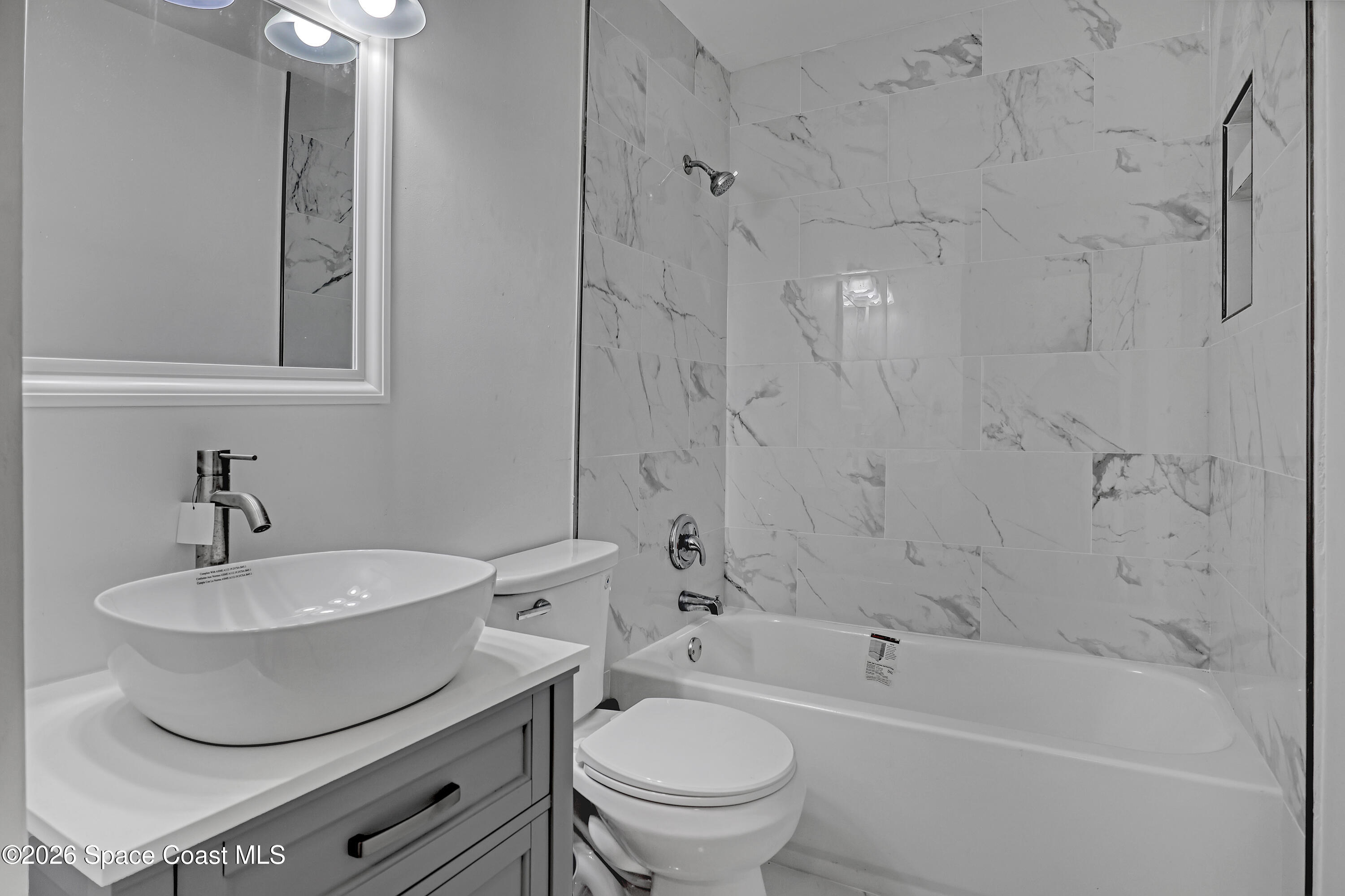 1051 Grove Avenue Cocoa, FL 32922 - Photo 22 of 38 a bathroom with a toilet a sink and bathtub
