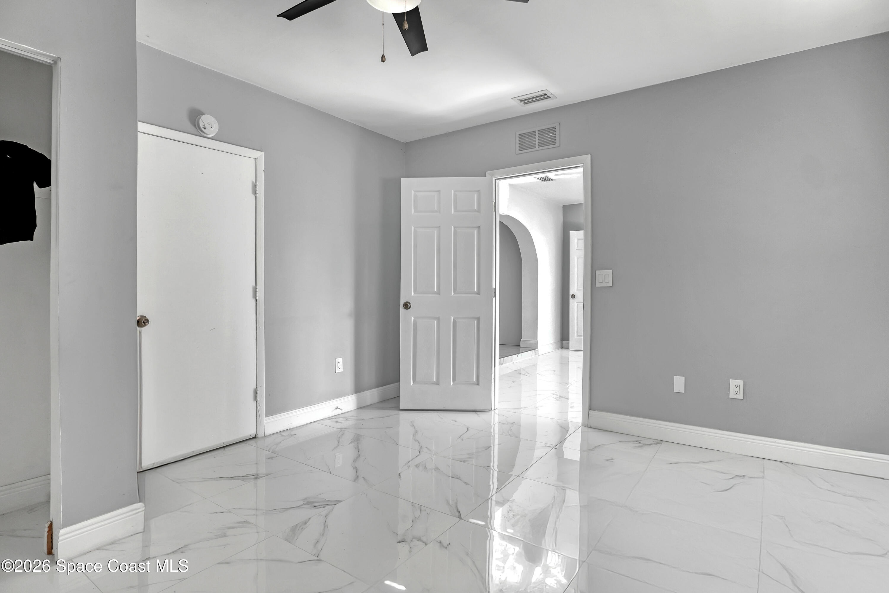 1051 Grove Avenue Cocoa, FL 32922 - Photo 25 of 38 an empty room with fan and entrance