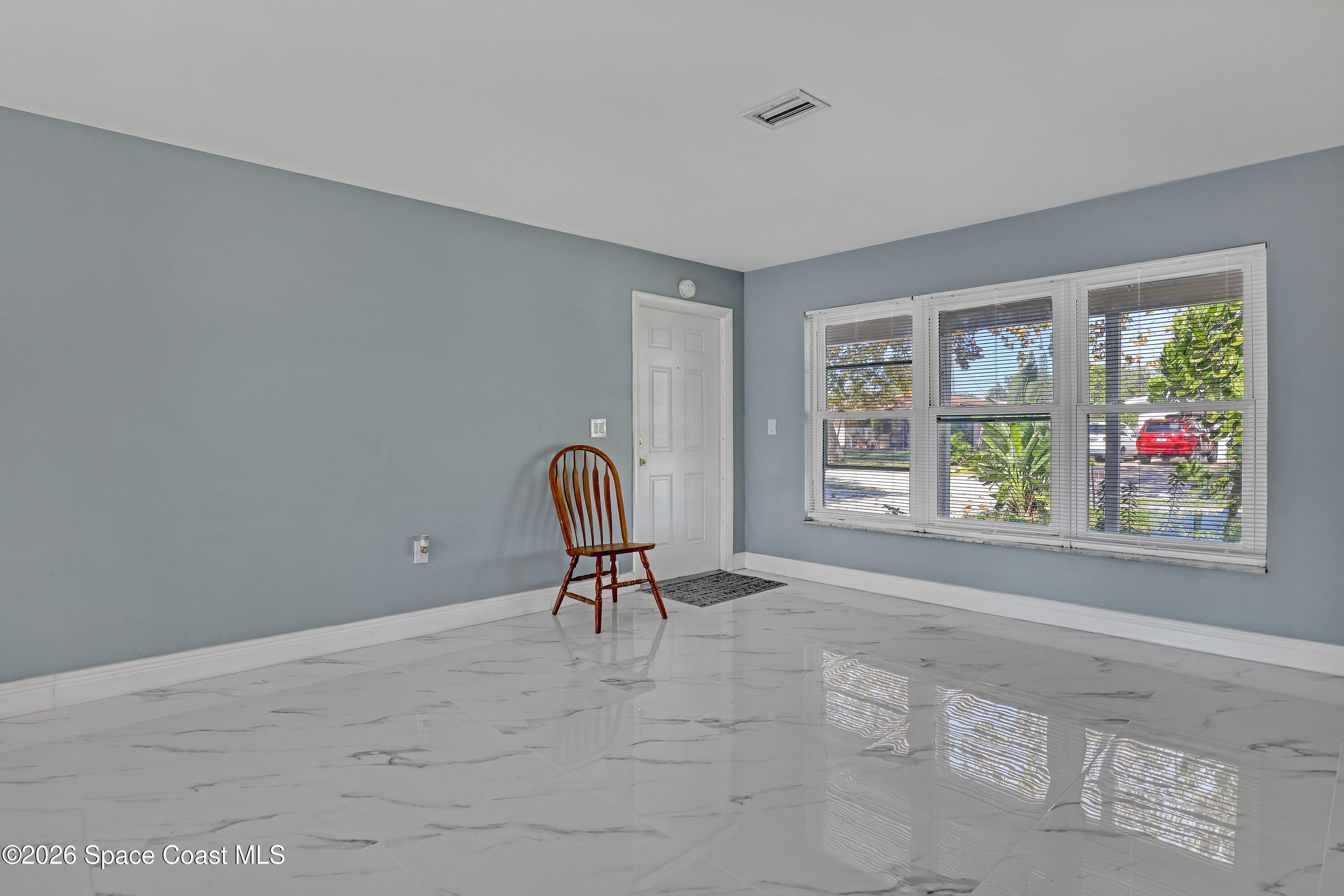 1051 Grove Avenue Cocoa, FL 32922 - Photo 7 of 38 a view of room with window and lounge chair