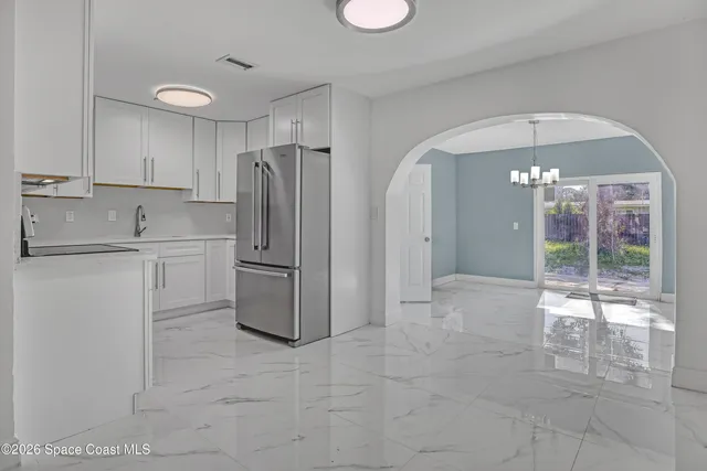 a kitchen with stainless steel appliances granite countertop a refrigerator and a sink