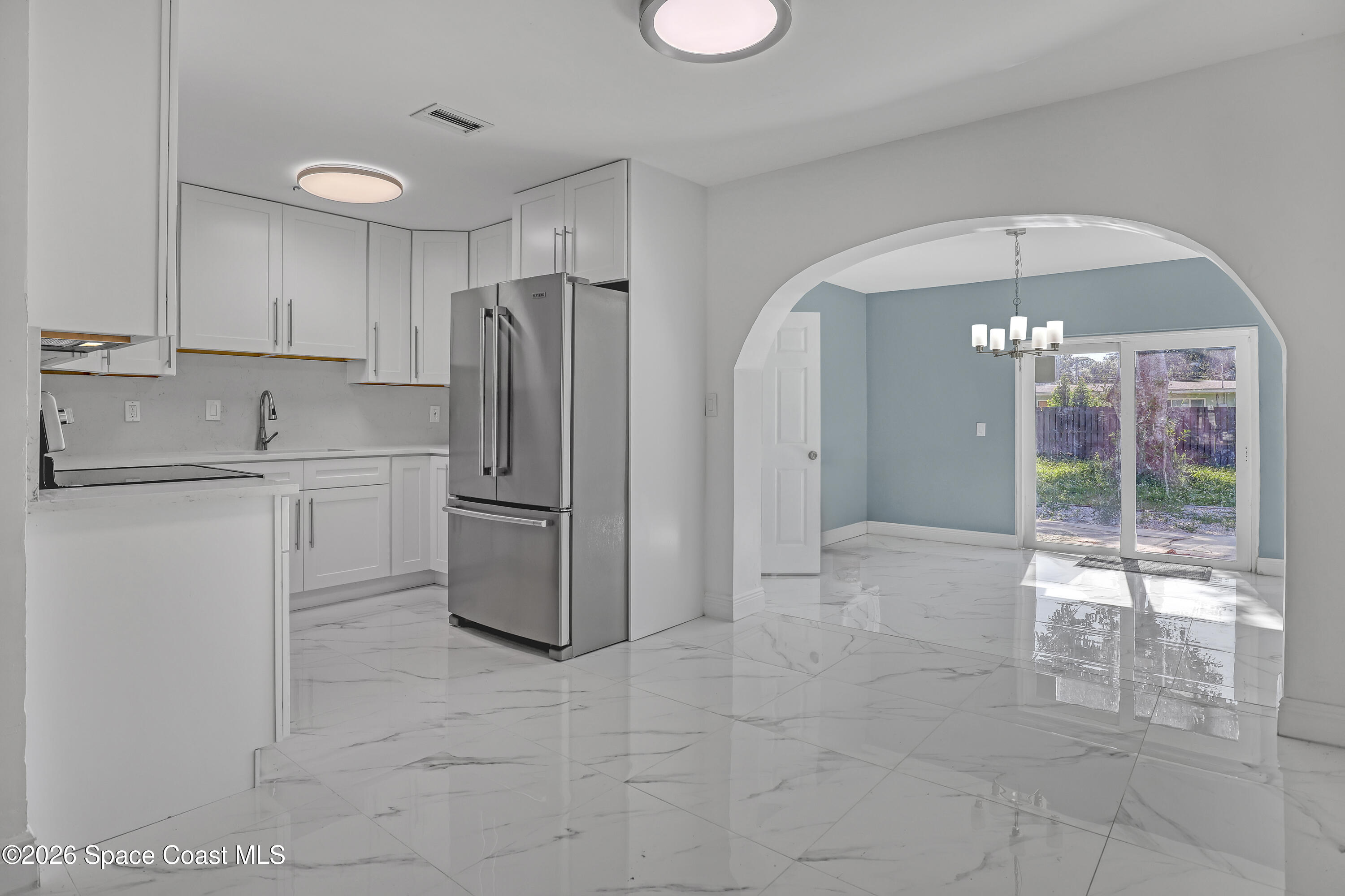 1051 Grove Avenue Cocoa, FL 32922 - Photo 8 of 38 a kitchen with stainless steel appliances granite countertop a refrigerator and a sink