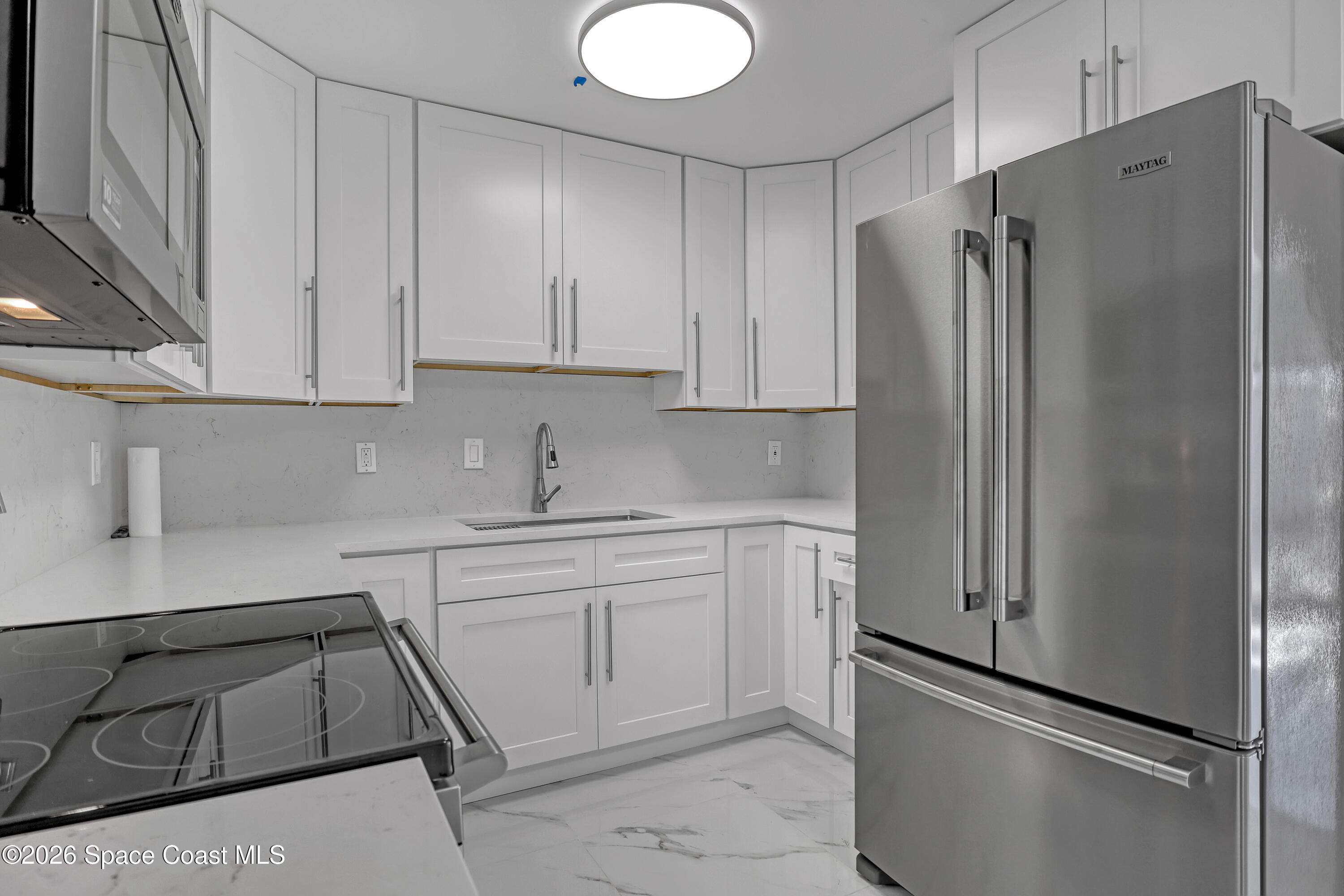 1051 Grove Avenue Cocoa, FL 32922 - Photo 10 of 38 a kitchen with a refrigerator sink and cabinets