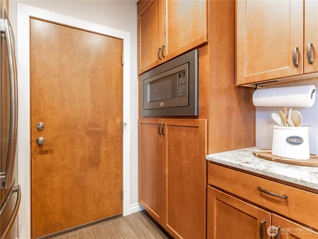 a kitchen with stainless steel appliances granite countertop a refrigerator and a sink