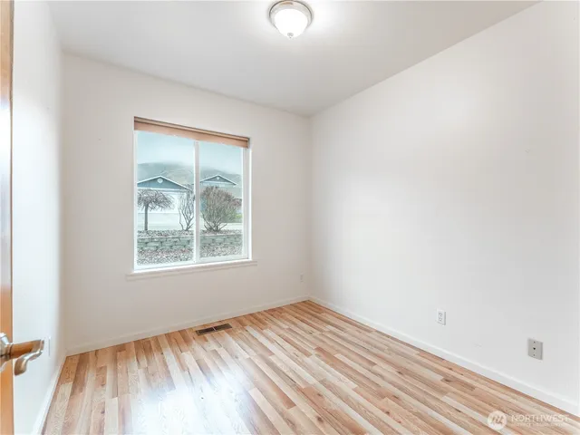 a bathroom with a granite countertop sink a toilet and a mirror