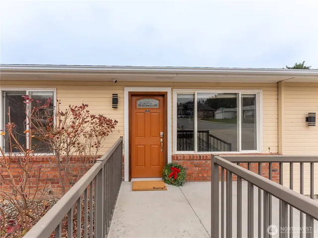 a large white kitchen with a stove top oven a fireplace and wooden floor