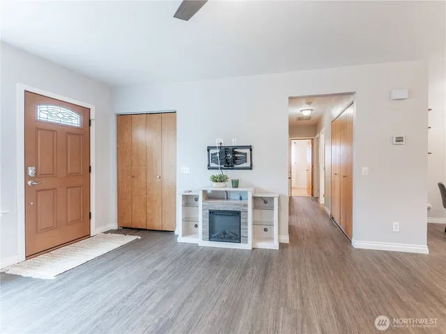 a kitchen with a table chairs refrigerator and cabinets